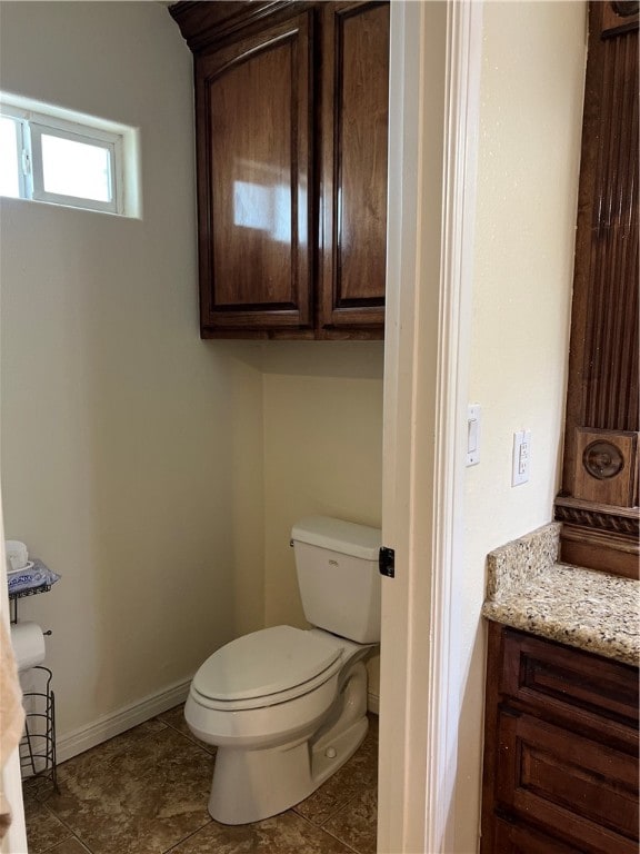 bathroom featuring toilet, vanity, and tile patterned floors