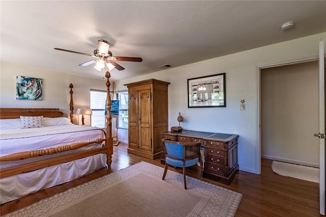bedroom featuring baseboards, visible vents, dark wood-style floors, and ceiling fan