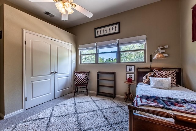 bedroom featuring visible vents, a ceiling fan, a closet, baseboards, and carpet flooring