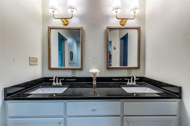 full bathroom with a sink and double vanity