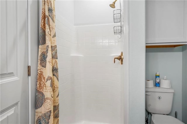 bathroom featuring walk in shower and toilet