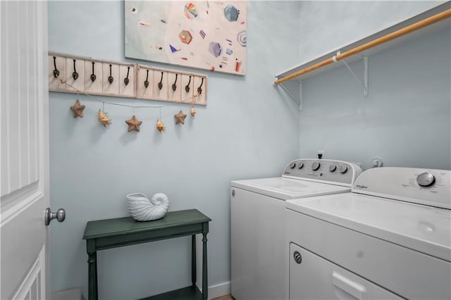 clothes washing area featuring separate washer and dryer