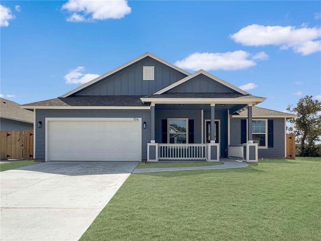 106 Broad Oak Dr, Rockport, TX 78382 - view of front of property with covered porch, a garage, board and batten siding, driveway, and roof with shingles