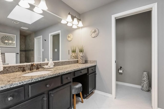15825 Cozumel Dr, Corpus Christi, TX 78418 - bathroom with a skylight, vanity, and a tile shower