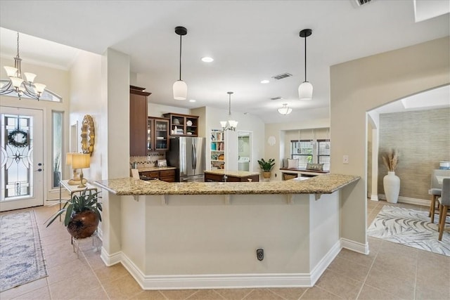 15825 Cozumel Dr, Corpus Christi, TX 78418 - kitchen featuring freestanding refrigerator, a chandelier, light tile patterned floors, a peninsula, and recessed lighting
