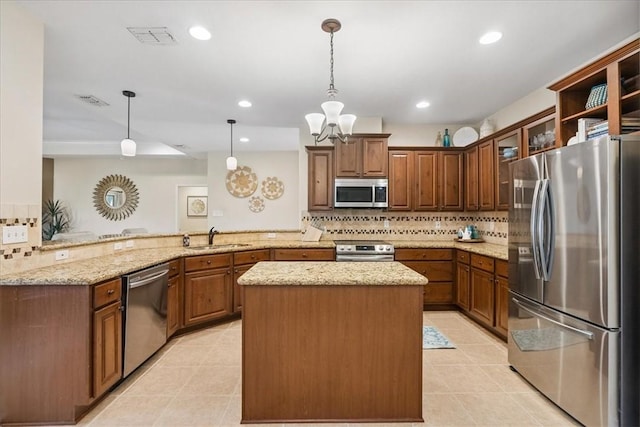 15825 Cozumel Dr, Corpus Christi, TX 78418 - kitchen with appliances with stainless steel finishes, a peninsula, light tile patterned floors, backsplash, and a center island
