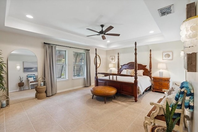 15825 Cozumel Dr, Corpus Christi, TX 78418 - bedroom featuring a tray ceiling, light tile patterned floors, arched walkways, recessed lighting, and crown molding