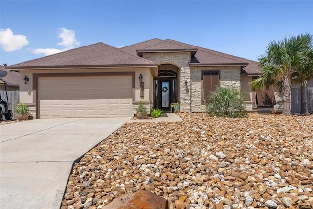 15825 Cozumel Dr, Corpus Christi, TX 78418 - view of front of property with stone siding, driveway, and a garage