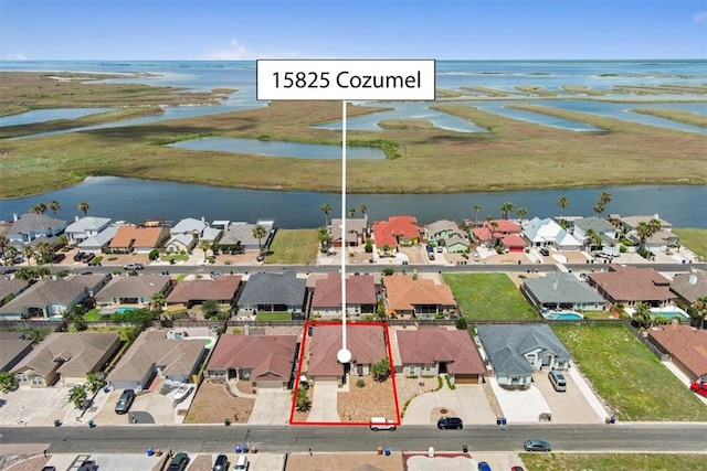 15825 Cozumel Dr, Corpus Christi, TX 78418 - aerial perspective of suburban area with a nearby body of water and property parcel outlined
