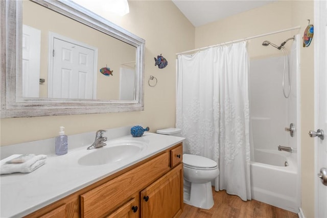 full bathroom featuring hardwood / wood-style flooring, vanity, shower / tub combo with curtain, and toilet