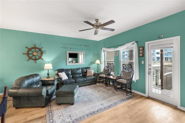 living room featuring ceiling fan and light hardwood / wood-style flooring