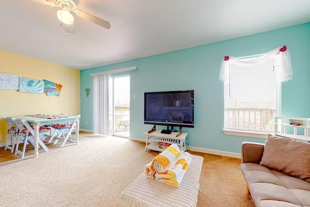 carpeted living room with ceiling fan