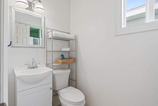 half bathroom featuring toilet and vanity