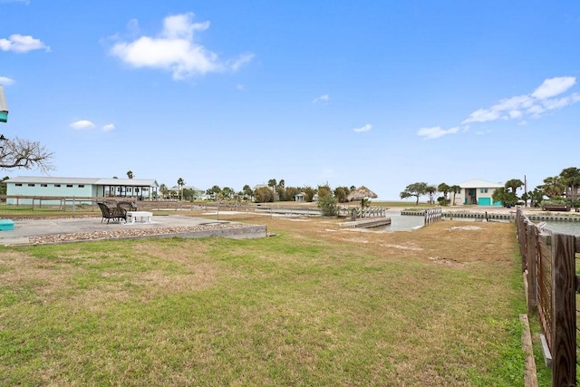 view of yard featuring a water view and fence