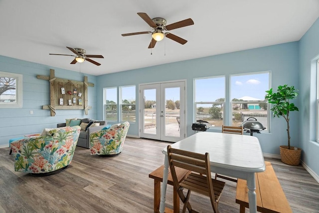 dining area with baseboards, wood finished floors, and french doors