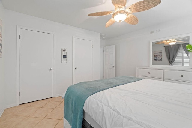 bedroom featuring light tile patterned floors and ceiling fan