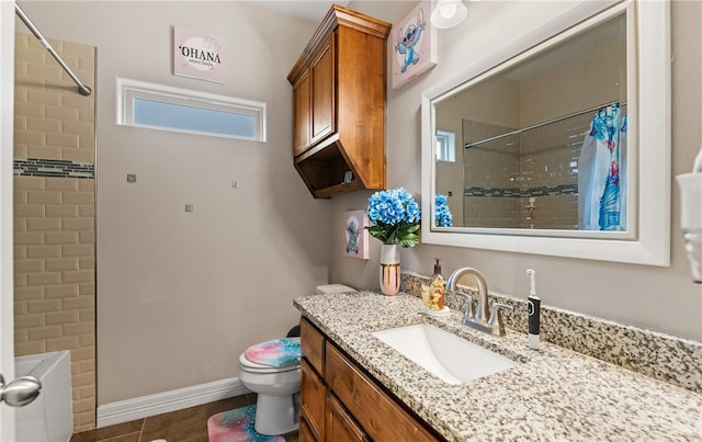 7622 Neches Dr, Corpus Christi, TX 78414 - full bathroom with a tile shower, vanity, toilet, and baseboards