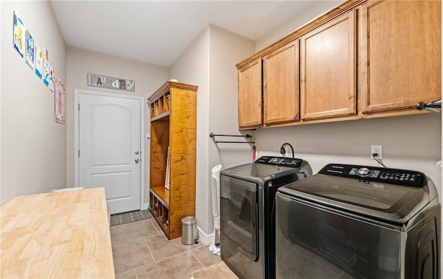7622 Neches Dr, Corpus Christi, TX 78414 - clothes washing area with washing machine and clothes dryer, light tile patterned flooring, cabinet space, and baseboards
