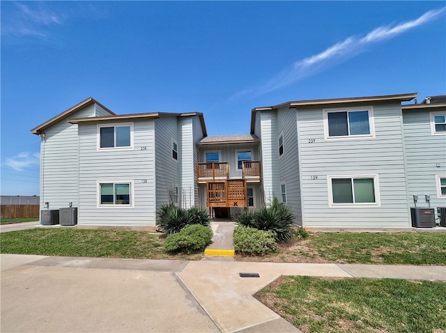 exterior space featuring a front yard and central AC