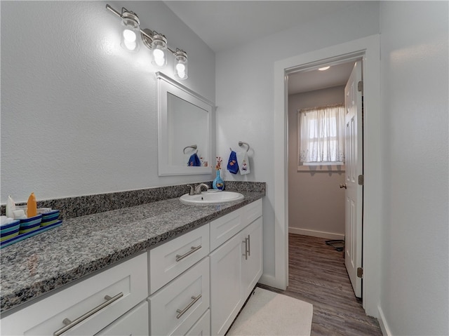 bathroom with hardwood / wood-style floors and vanity