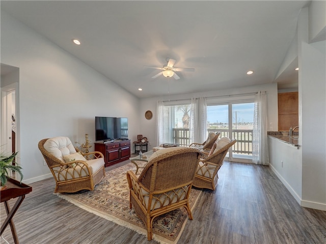 living room with lofted ceiling, ceiling fan, and dark hardwood / wood-style floors