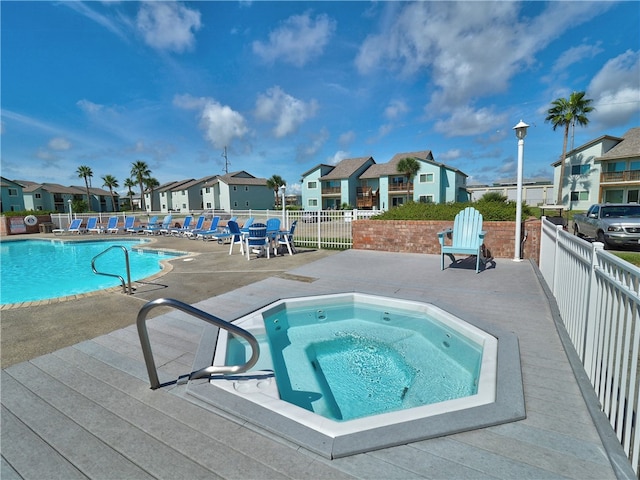 view of swimming pool featuring a patio area and a community hot tub