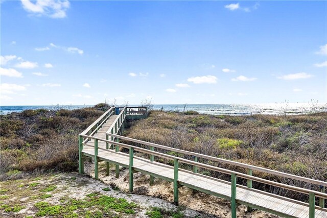 exterior space featuring a water view and a view of the beach