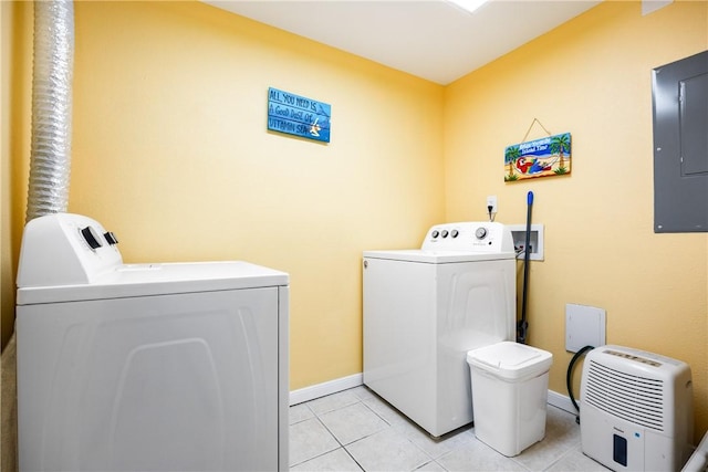 washroom with light tile patterned floors, electric panel, and washer and clothes dryer