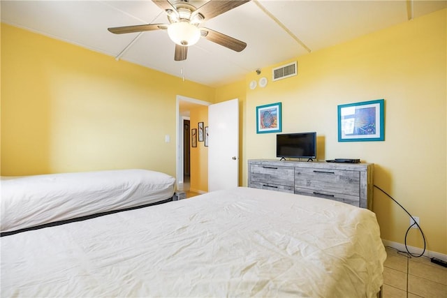 tiled bedroom featuring ceiling fan