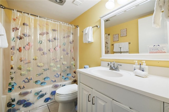 full bathroom featuring toilet, vanity, tile patterned floors, and shower / bath combo with shower curtain