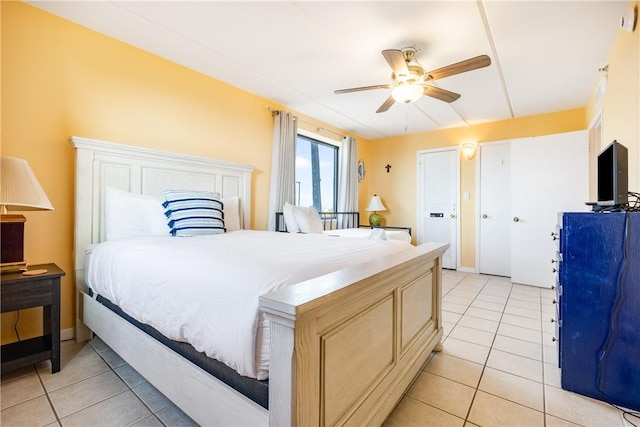 tiled bedroom featuring ceiling fan