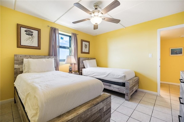 tiled bedroom with ceiling fan