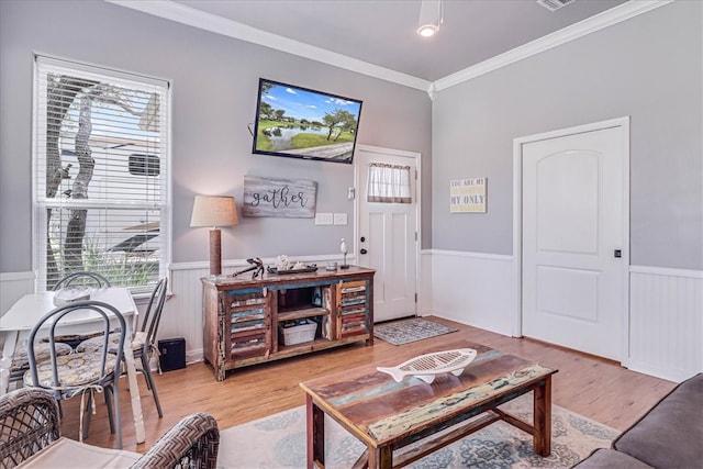 living room featuring ornamental molding and hardwood / wood-style flooring