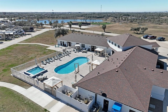 view of pool with a water view and a patio