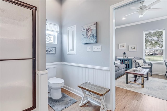 bathroom featuring a wealth of natural light, hardwood / wood-style floors, and ornamental molding