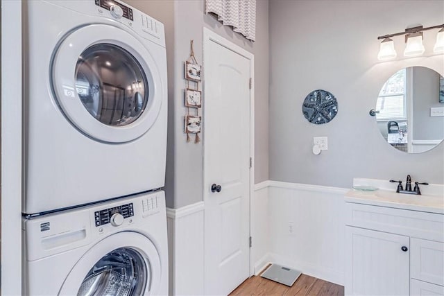 77 Augusta Cir, Aransas Pass, TX 78336 - washroom featuring stacked washing machine and dryer and light wood-style flooring