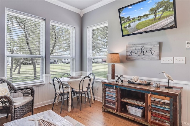 sitting room with hardwood / wood-style floors, a healthy amount of sunlight, and crown molding