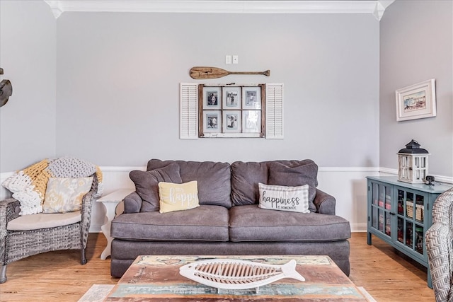 living room featuring wood-type flooring and ornamental molding