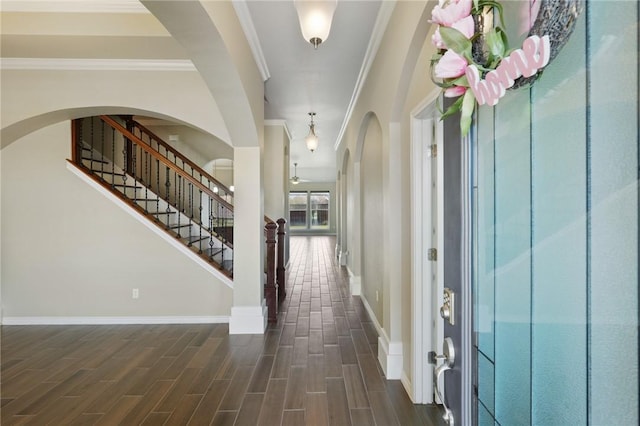 420 Palmer Dr, Portland, TX 78374 - entryway featuring crown molding, baseboards, stairway, dark wood-style flooring, and arched walkways