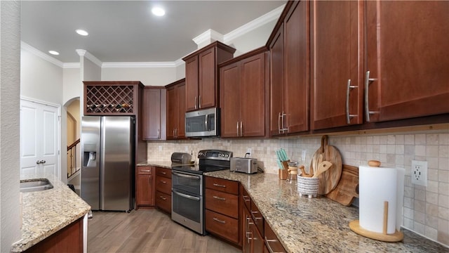 420 Palmer Dr, Portland, TX 78374 - kitchen with stainless steel appliances, crown molding, light stone countertops, decorative backsplash, and light wood-style flooring