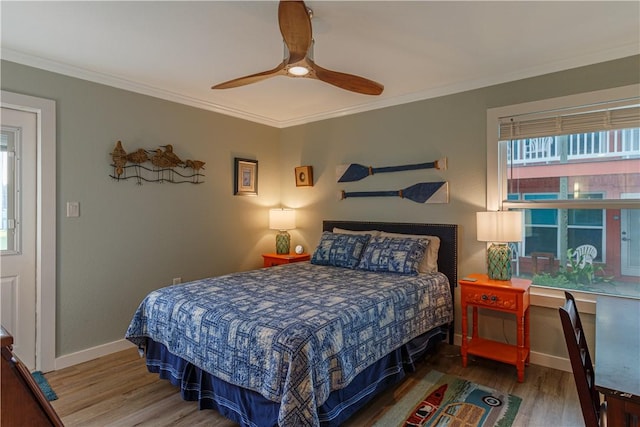 bedroom with wood-type flooring, ornamental molding, and ceiling fan