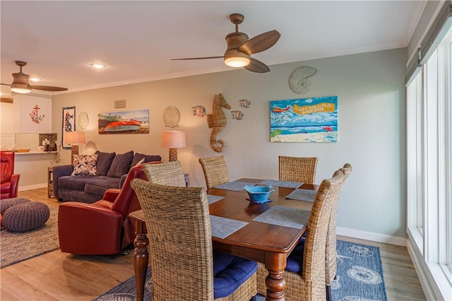 dining room with crown molding, hardwood / wood-style floors, and ceiling fan