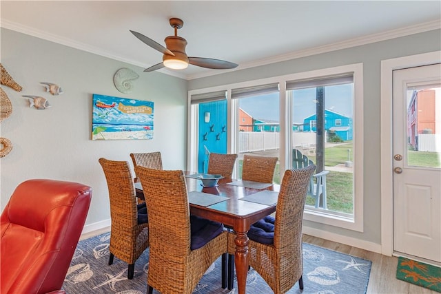 dining room featuring hardwood / wood-style flooring, ornamental molding, and ceiling fan