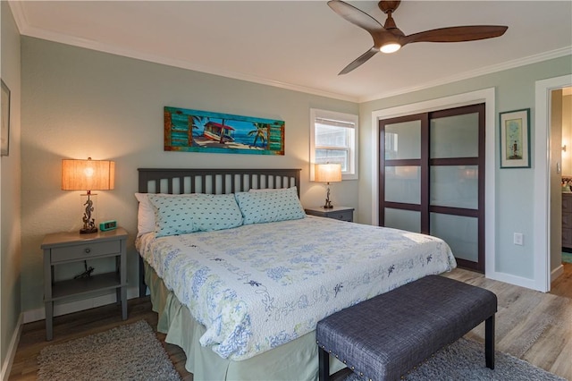 bedroom with crown molding, ceiling fan, and wood-type flooring