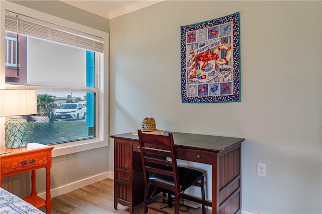 office space with ornamental molding and light hardwood / wood-style floors