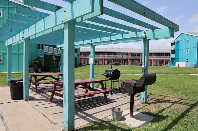 view of home's community with a yard, a pergola, and a patio