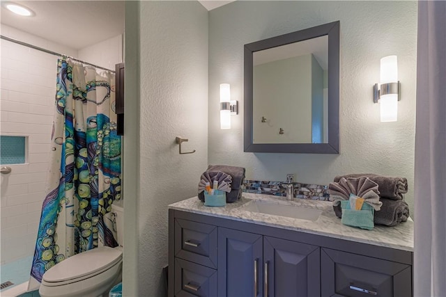 bathroom featuring vanity, toilet, and curtained shower