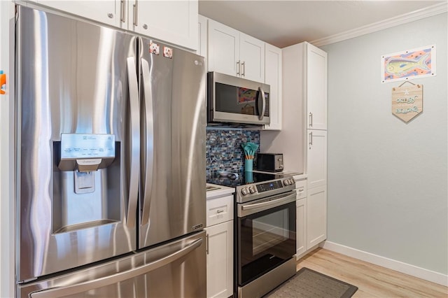 kitchen featuring white cabinetry, crown molding, tasteful backsplash, light wood-type flooring, and appliances with stainless steel finishes