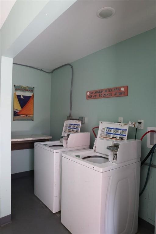 clothes washing area with washing machine and dryer