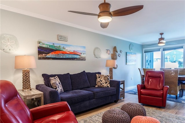 living room with ceiling fan, ornamental molding, and light hardwood / wood-style floors